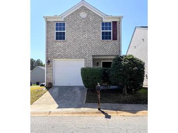 Charming two-story home with a brick facade, attached garage, and well-maintained landscaping at 2089 Belmont Cir, Conyers, GA 30012