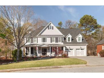 Traditional two-story home with a manicured front lawn and a three-car garage, perfect for a Gathering at 6236 Benbrooke Nw Dr, Acworth, GA 30101