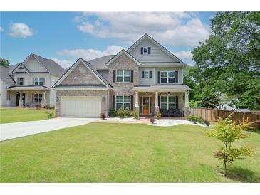 Beautiful two-story home featuring brick accents, a well-manicured lawn, and a two-car garage at 2589 Cajun Dr, Marietta, GA 30066