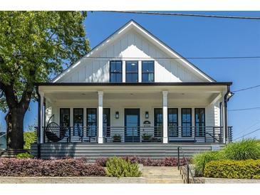 Charming two-story home with a welcoming front porch and manicured landscaping, perfect for curb appeal at 1076 Manigault Se St, Atlanta, GA 30316