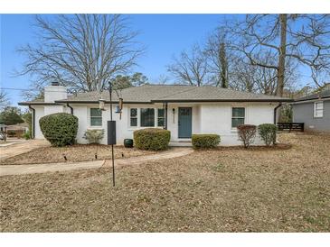 Charming home featuring well-maintained landscaping, a brick facade, and a cozy entryway, creating inviting curb appeal at 2265 Starline Dr, Decatur, GA 30032