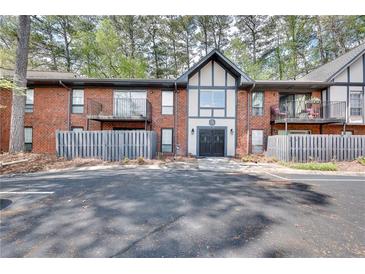 Charming townhome with brick facade, private balconies, and manicured landscaping in a desirable neighborhood at 6851 Roswell Rd # A21, Sandy Springs, GA 30328