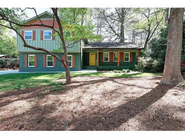 Charming two-story home with colorful exterior, green lawn and shade trees at 2538 Three Bars Drive, Grayson, GA 30017
