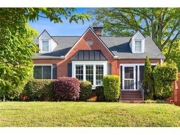 Charming brick home with a well-manicured lawn and mature landscaping at 479 Shannon Sw Dr, Atlanta, GA 30310