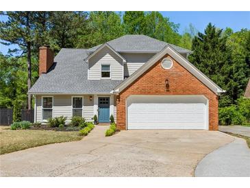 Charming two-story home with brick accents and a well-manicured front yard at 550 Ambergate Ct, Roswell, GA 30076
