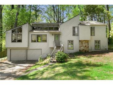 Bright two-story home featuring a two-car garage, stone accents and a inviting front entrance at 3923 Lookout Point Dr, Marietta, GA 30066