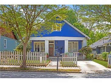 Charming blue two-story home with a inviting front porch and picket fence, perfect for relaxing outdoors at 836 Dill Sw Ave, Atlanta, GA 30310