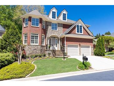 Beautiful two-story home with stone accents, manicured lawn, and a two-car garage at 3759 Wescott Ne Cv, Brookhaven, GA 30319