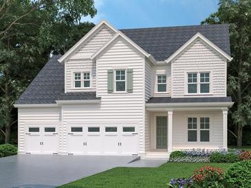 Charming two-story home with a three-car garage and beautifully landscaped front yard at 3375 Hillshire Dr, Cumming, GA 30028