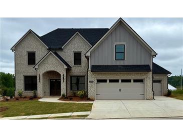 Charming two-story home with brick and siding, complemented by a well-manicured lawn at 4201 Hosch Reserve Dr, Buford, GA 30519