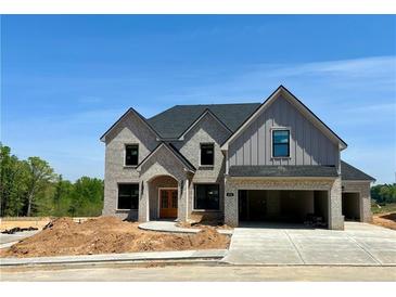 Beautiful new construction featuring a gray brick facade and an attached two-car garage at 4201 Hosch Reserve Dr, Buford, GA 30519