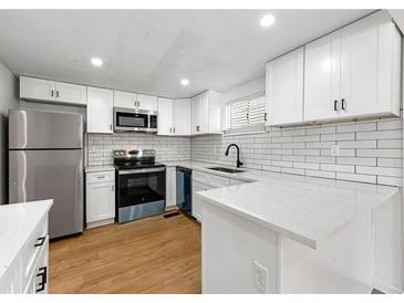 Modern kitchen with white cabinets, stainless steel appliances, and subway tile backsplash at 1917 Connally Dr, Atlanta, GA 30344