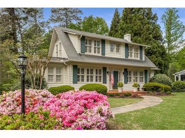 Charming two-story home with a landscaped front yard and a walkway leading to the front porch at 4220 Club Ne Dr, Atlanta, GA 30319