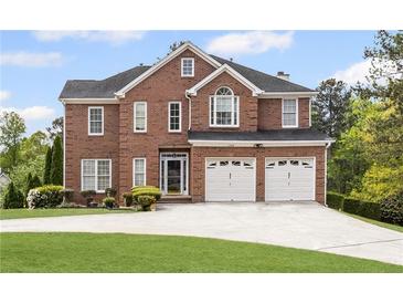Stately two-story brick home featuring a two-car garage and manicured front lawn at 1268 Windsor Glen Dr, Douglasville, GA 30134
