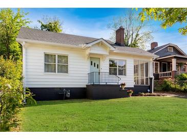 Charming home with light blue door, black trim, and a well-maintained lawn at 1575 Linda Sw Way, Atlanta, GA 30310