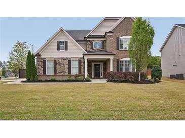 Beautiful two-story home with brick and siding, manicured lawn, and tasteful landscaping at 2100 Baywood Sw Blvd, Austell, GA 30106