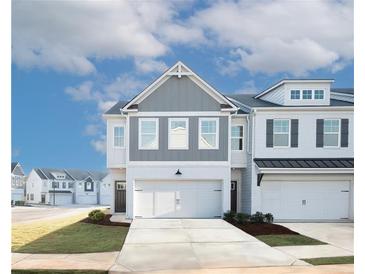 Charming two-story townhome with an attached garage and well-manicured landscaping for a welcoming curb appeal at 1567 Aiden Way # 34, Conyers, GA 30013