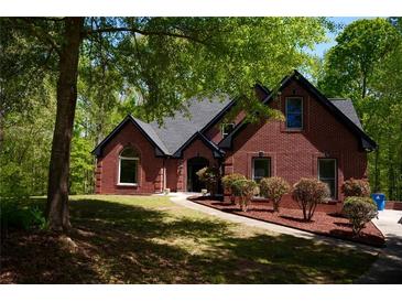 Charming brick home with landscaped front yard and manicured lawn; inviting curb appeal at 225 Austin Oaks Se Dr, Ellenwood, GA 30294