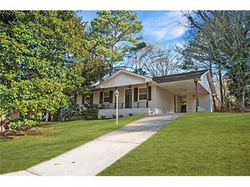 Charming single-story home featuring a brick facade, cozy front porch, and an inviting carport at 2198 Star Mist Sw Dr, Atlanta, GA 30311
