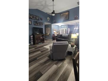Comfortable living room featuring wood floors, ceiling fan, and comfortable seating at 12 Little Creek Manor Dr, Dallas, GA 30157