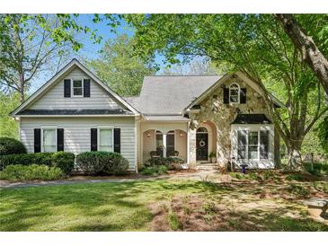 Charming single-Gathering home with stone accents, a well-manicured lawn, and a welcoming entrance at 2095 Southers Cir, Suwanee, GA 30024