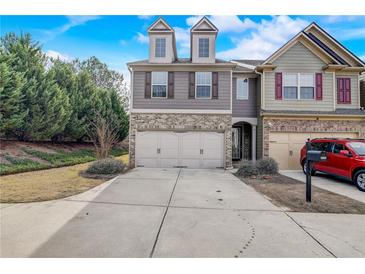Charming townhome with a two-car garage and well-maintained front yard in a Gathering-friendly neighborhood at 2722 Sardis Chase Ct, Buford, GA 30519