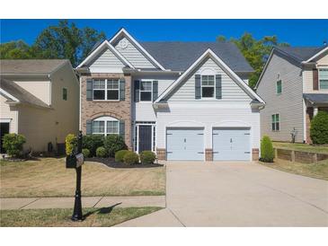 Charming two-story home with a well-manicured lawn and a two-car garage at 175 Diamond Ridge Ave, Canton, GA 30114