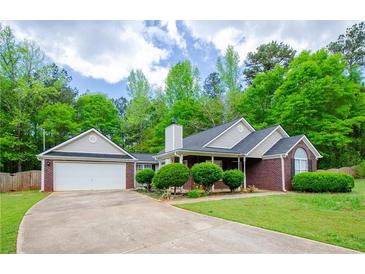 Charming brick home with well-manicured lawn, attached garage, and inviting curb appeal at 238 Knob Hill Dr, Locust Grove, GA 30248