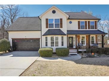 Charming two-story home with a welcoming front porch and a well-manicured lawn, boasting great curb appeal at 161 Hunters Chase, Mcdonough, GA 30253