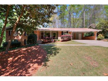 Charming brick home featuring a well-maintained lawn and a convenient covered carport at 1531 Cooper Lake Se Rd, Smyrna, GA 30082