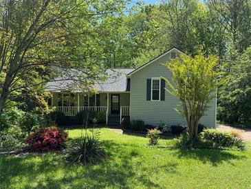 Charming home with a covered front porch and lush landscaping at 861 Creek Nw Trl, Kennesaw, GA 30144