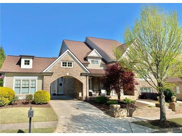 Beautiful brick home featuring a portico, manicured landscaping, and charming curb appeal at 311 Carmichael Cir, Canton, GA 30115