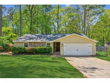 Charming ranch home with a one-car garage, stone accents, and a well-manicured lawn at 4425 Reef Rd, Marietta, GA 30066