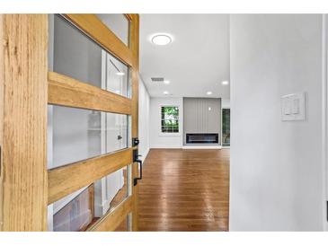 Inviting entryway featuring a modern wood door with glass panes and hardwood floors at 800 Kiowa Ne Dr, Marietta, GA 30060