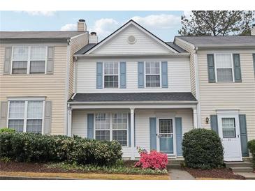 Charming two-story townhouse with blue shutters and a well-maintained front garden at 10900 Wittenridge Dr # I4, Alpharetta, GA 30022