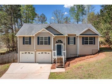 Charming two-story home with a well-manicured lawn, inviting entrance, and a two-car garage at 33 Blue Springs Way, Dallas, GA 30157
