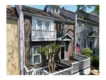 Charming two-story townhome features a welcoming front porch and classic architectural details at 957 Piedmont Ne Ave # A, Atlanta, GA 30309