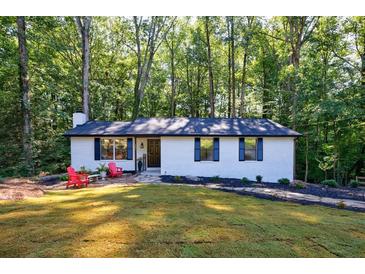 Charming home with freshly painted brick, black shutters, and lovely landscaping creates a welcoming curb appeal at 151 John Christopher Dr, Alpharetta, GA 30009