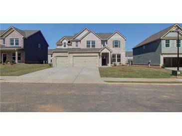 Charming two-story home with a two car garage and a well-manicured lawn at 2366 Cadenza Cir, Dacula, GA 30019