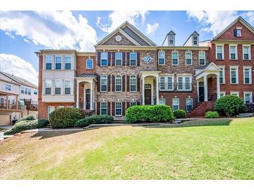 Attractive multi-story townhome with a brick facade, shutters, manicured lawn, and a welcoming entrance at 2145 Shoop Se Ct # 3, Smyrna, GA 30080