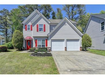 Charming two-story home featuring red shutters and a two-car garage at 2477 Lakebrooke Dr, Marietta, GA 30066