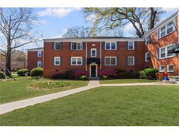 Charming red brick building with well-manicured lawn and vibrant azalea bushes at 542 Goldsboro Ne Rd # C, Atlanta, GA 30307