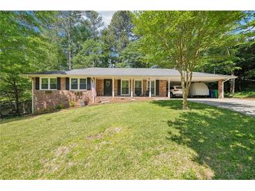 Charming brick home with a lush lawn, covered carport, and a welcoming front porch at 2324 Bry Mar Ne Dr, Atlanta, GA 30345