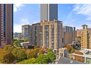 A full exterior view of the building showing its height in the city skyline and surrounding trees at 620 Peachtree Ne St # 1412, Atlanta, GA 30308