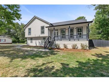 Beautifully renovated two-story home featuring a charming front porch and mature trees at 3457 Skyview Dr, Lithia Springs, GA 30122