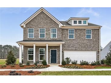 Charming two-story home featuring a gray brick facade, covered porch, and manicured landscaping at 6102 Marigold Way, Atlanta, GA 30349
