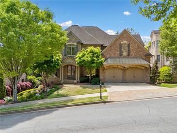 Charming two-story brick home with manicured landscaping and a two-car garage at 1045 Westcroft Ln, Roswell, GA 30075
