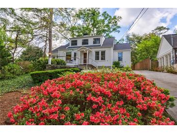 Charming two-story home with a landscaped yard and vibrant red azaleas in the front at 2840 Alpine Rd, Atlanta, GA 30305