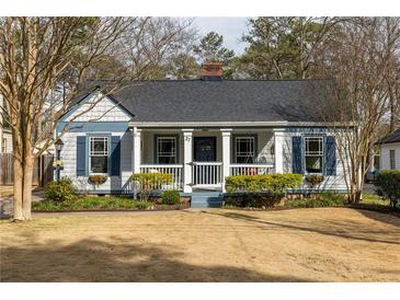 Charming cottage-style home with blue and white accents, covered porch, and inviting curb appeal at 27 Spence Ne Ave, Atlanta, GA 30317
