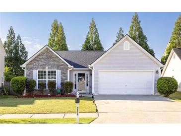 Charming single-Gathering home with stone accents, manicured lawn, and attached two car garage at 4924 Antelope Cv, Atlanta, GA 30349